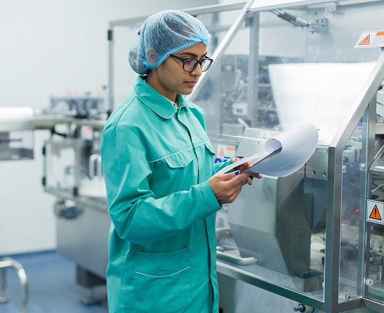 Pharma worker checking a production line